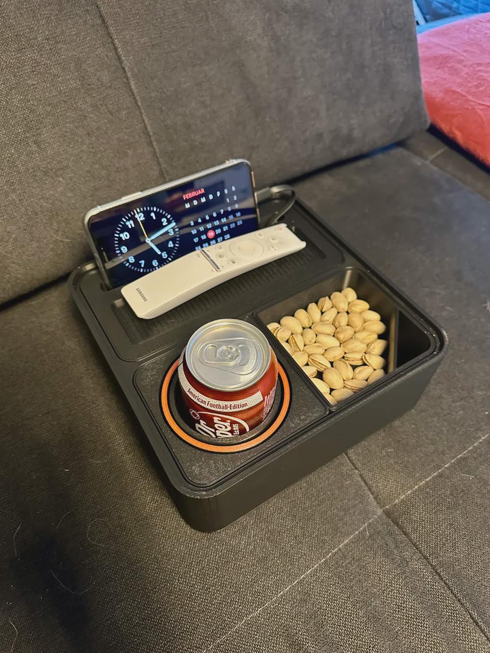 Phone snack caddy holding a smartphone drink and pistachios