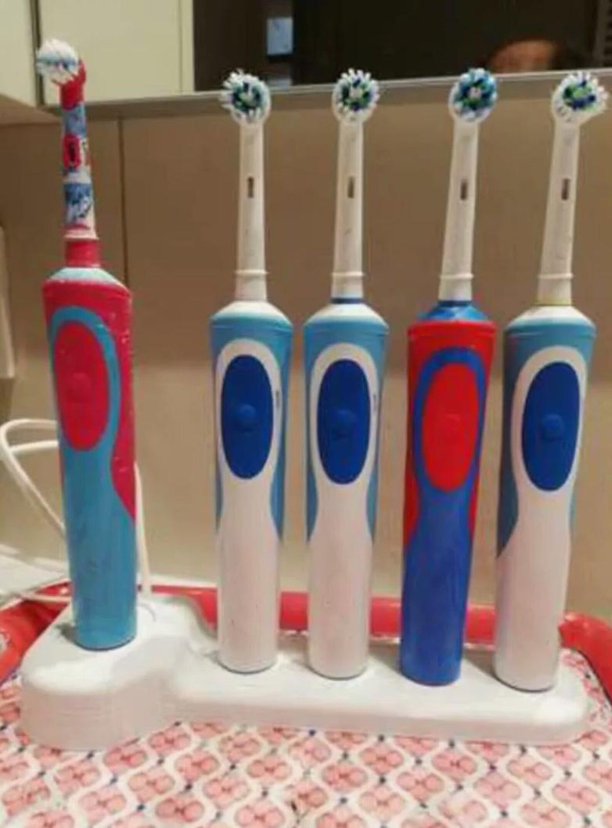 Five toothbrushes arranged in the stand