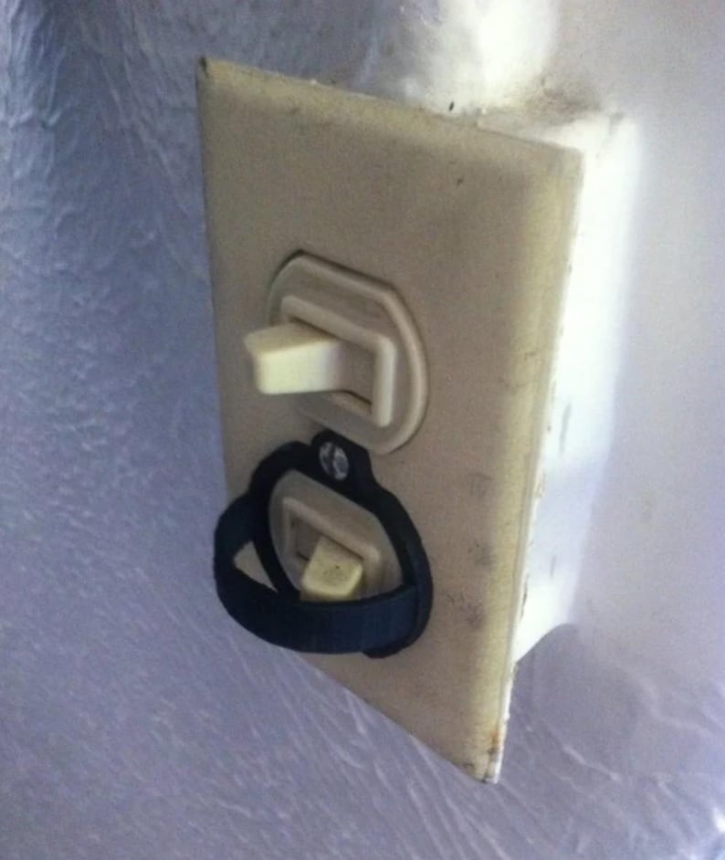 Horizontal rocker light switch cover installed over a wall switch
