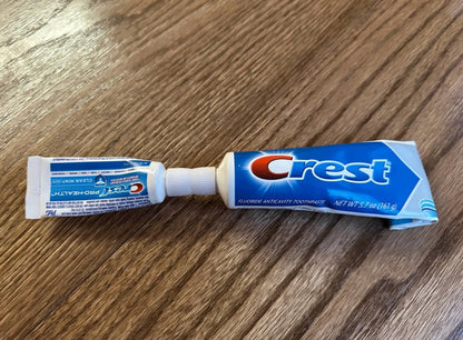Travel toothpaste transfer adapter connecting a full-size and travel-size tube