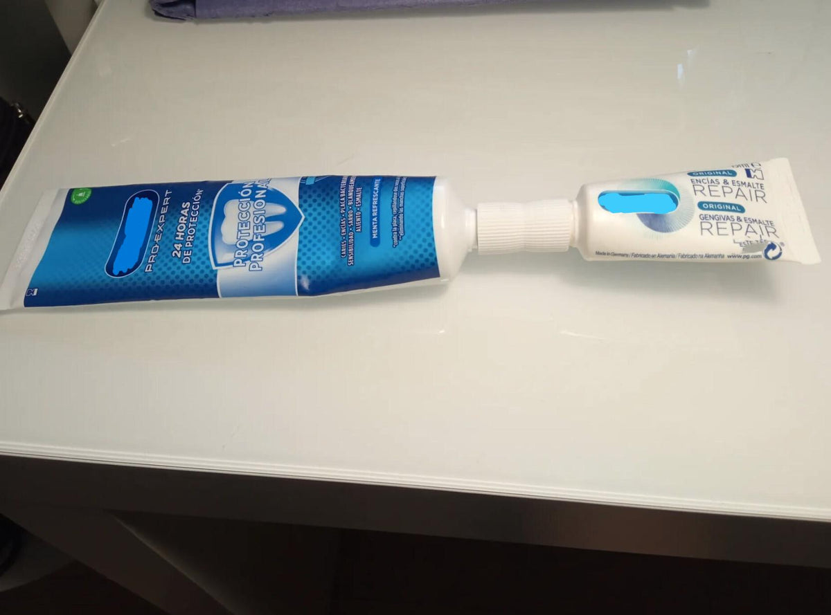 Toothpaste transfer adapter joining two dental care tubes