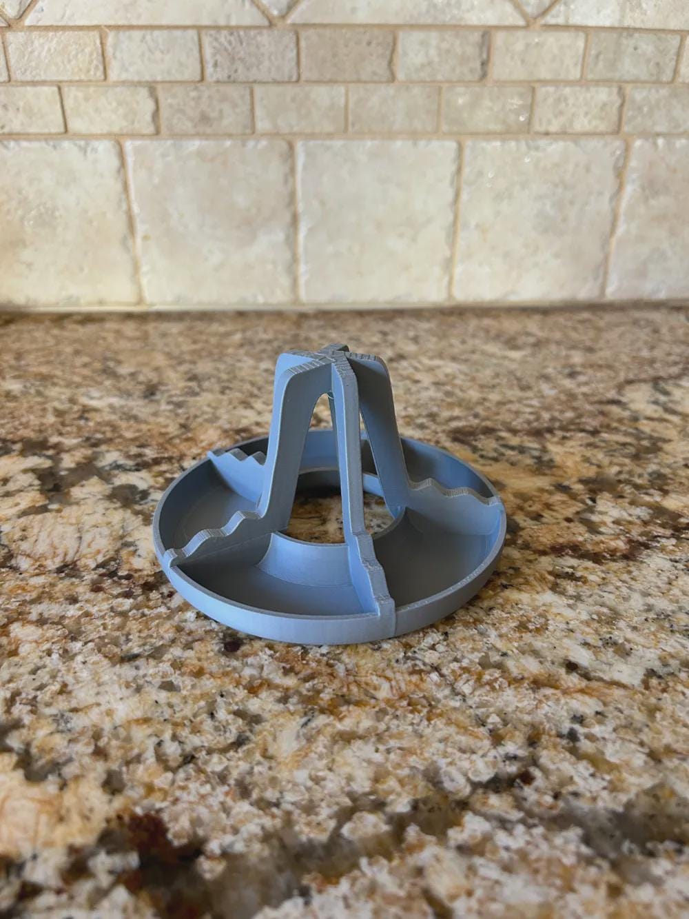 Gray stackable bottle drying rack on a kitchen counter