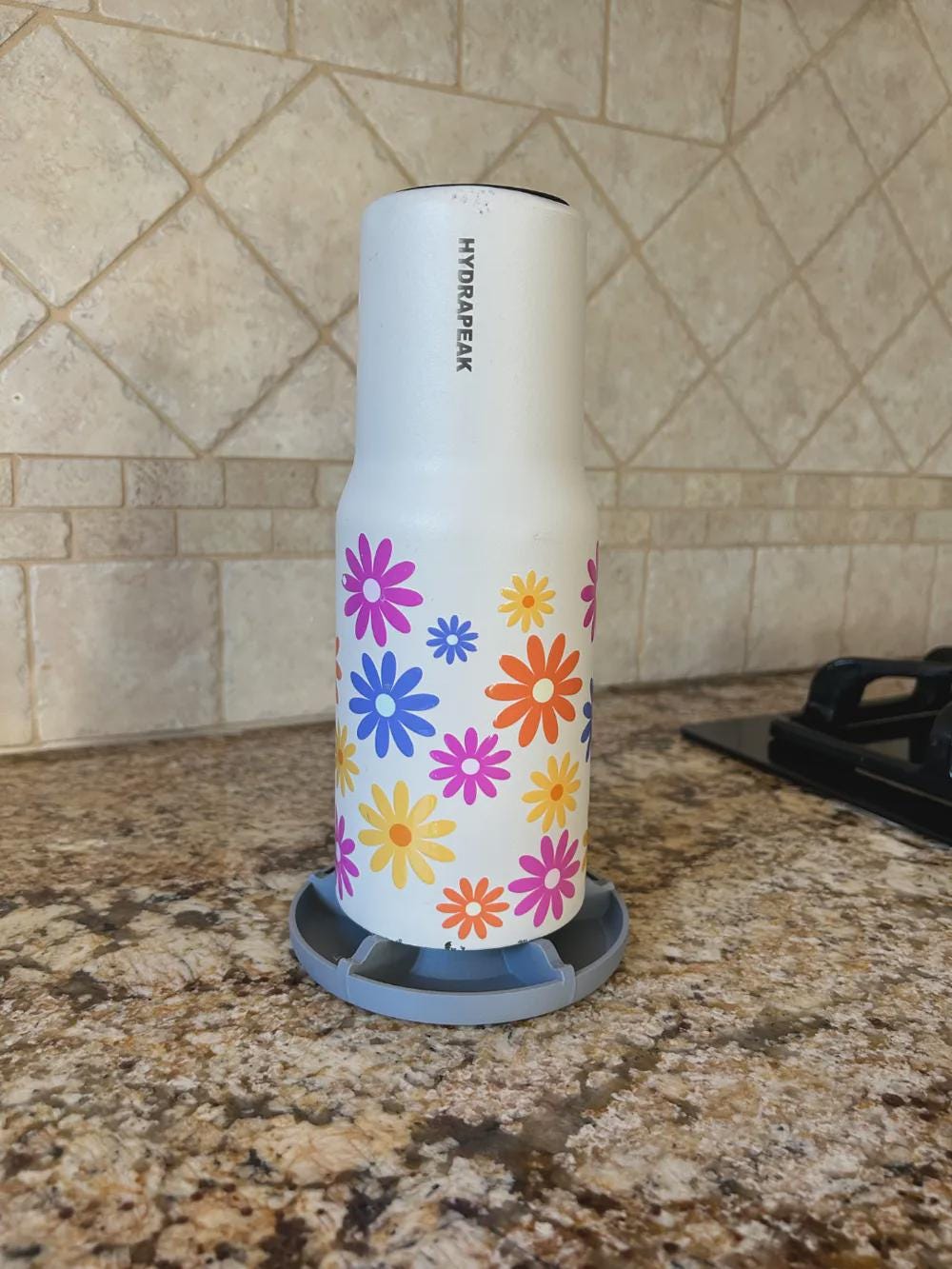 Tumbler drying upside down on a drip tray stand