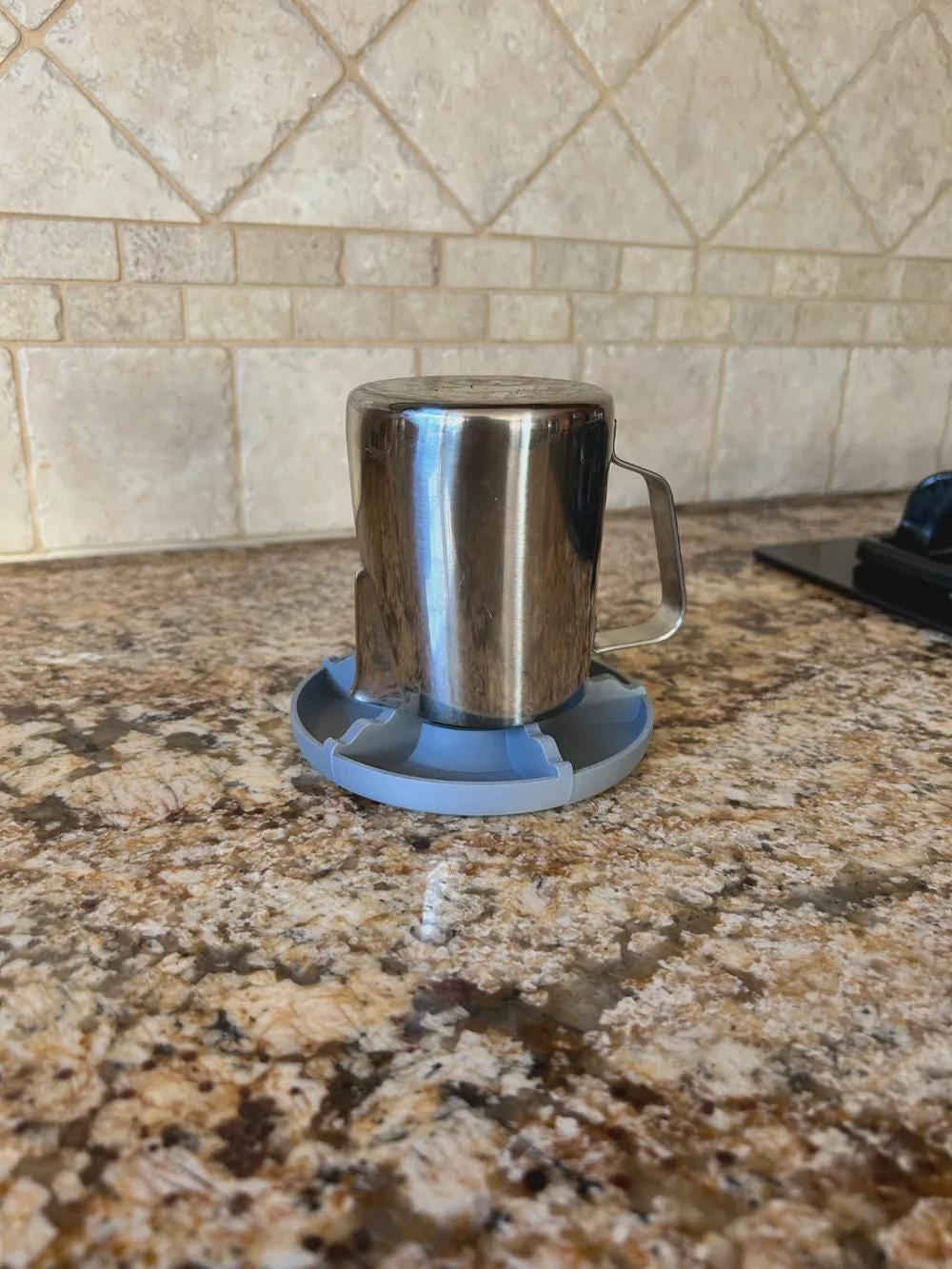 Metal mug drying upside down on the rack