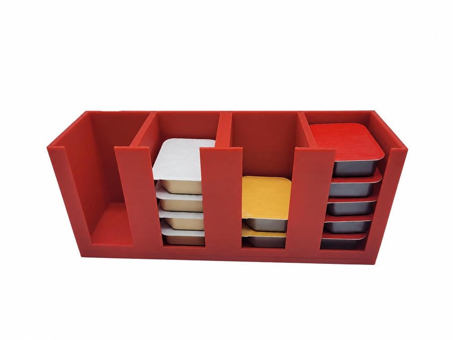 Four-compartment sauce packet organizer filled with takeout condiments