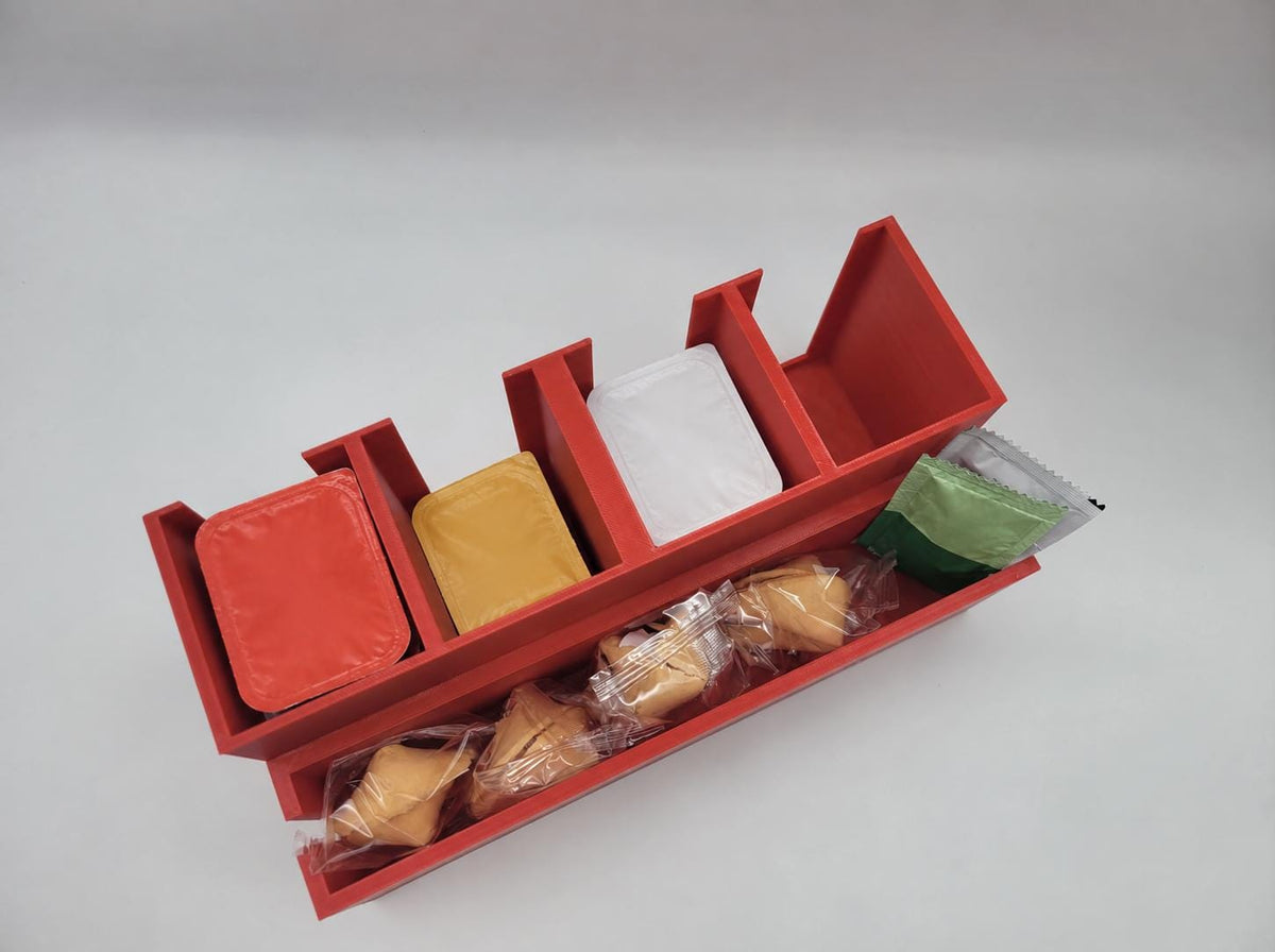 Sauce cup and packet dispenser on a counter