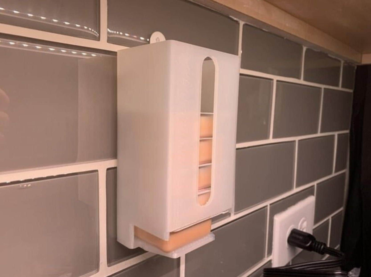 Red wall-mounted sauce packet dispenser holding condiments
